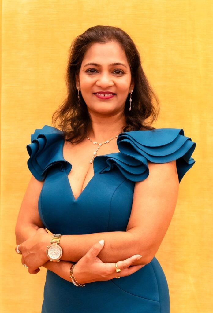 Parul Garg, CEO and Co-Founder of PracticeForces, smiling in a blue dress with ruffled sleeves, showcasing her leadership in healthcare and entrepreneurship.
